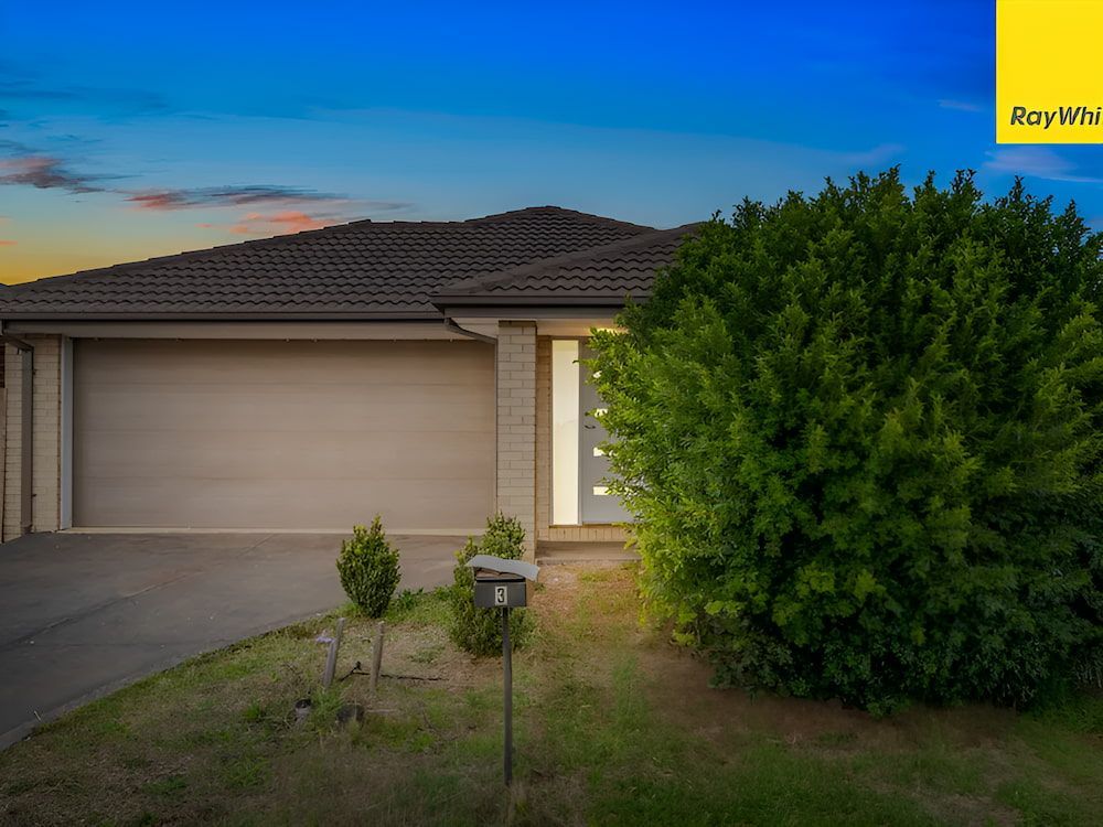 A House With A Large Garage And A Mailbox In Front Of It — Romy Sidhu Ray White Weir Views In Melton, VIC