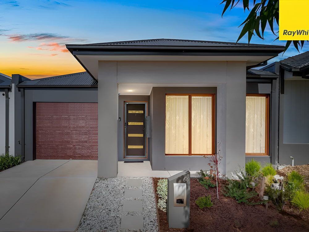 The Front Of A House With A Garage And A Sunset In The Background — Romy Sidhu Ray White Weir Views In Melton, VIC