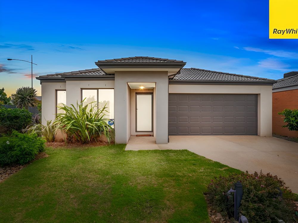 A Modern House With A Large Lawn In Front Of It — Romy Sidhu Ray White Weir Views In Melton, VIC