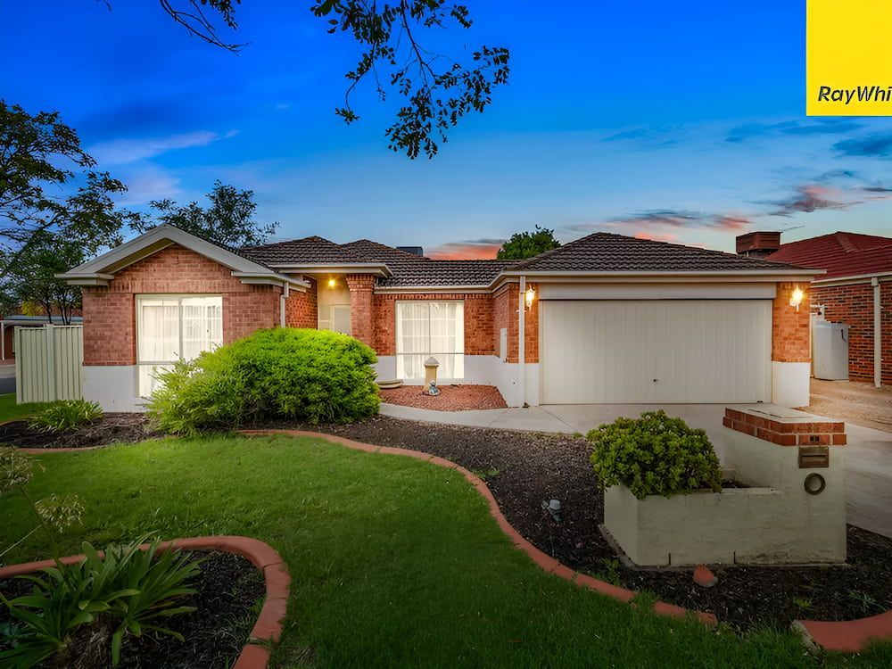 A Brick House With A White Garage Door Is For Sale — Romy Sidhu Ray White Weir Views In Melton, VIC