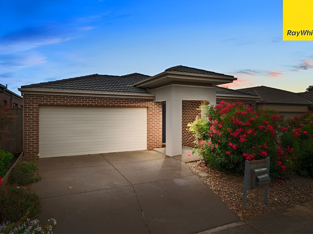 The Front Of A House With A White Garage Door And A Brick Wall — Romy Sidhu Ray White Weir Views In Melton, VIC