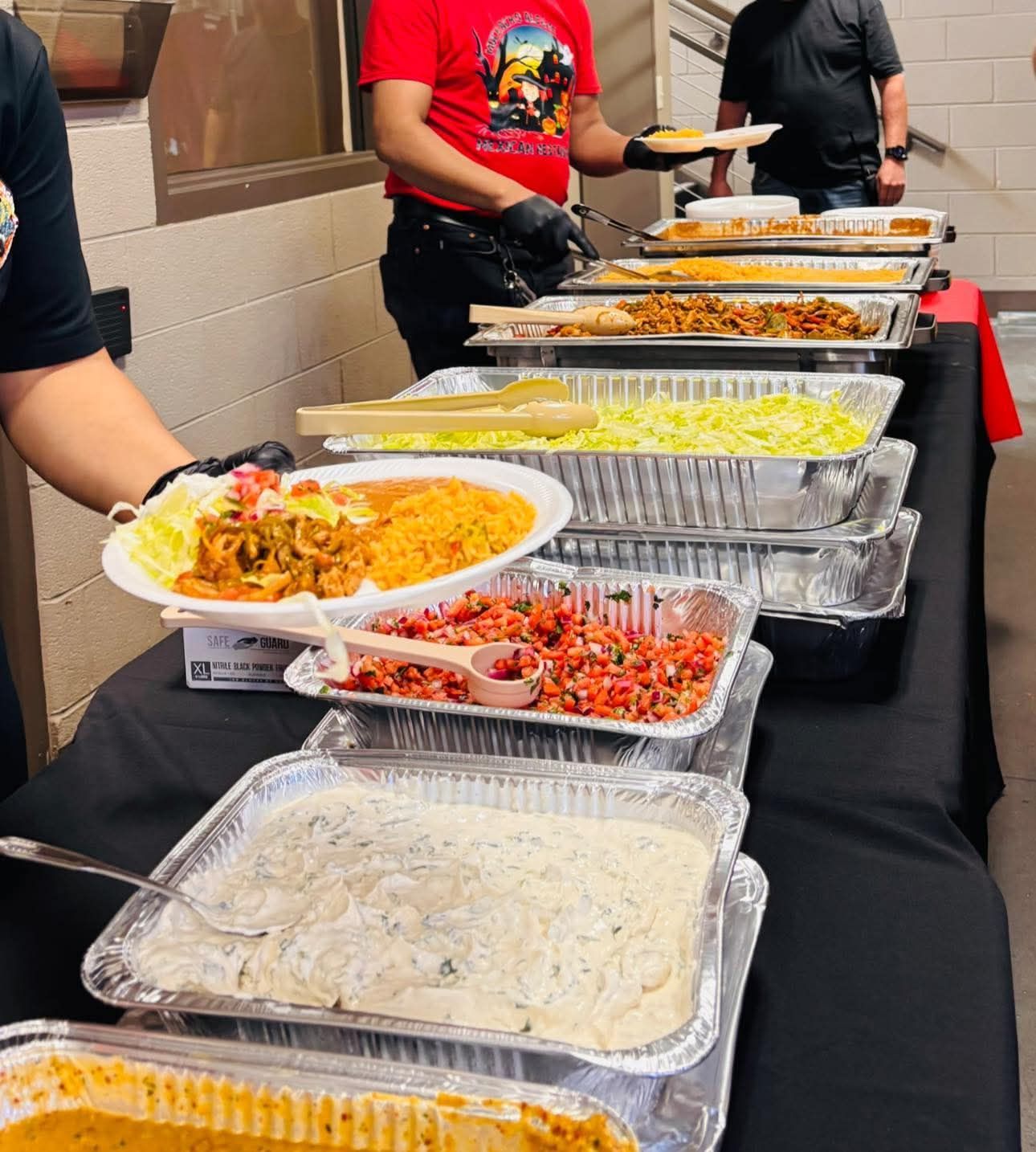 Mexican fajitas with rice and beans on a yellow plate.