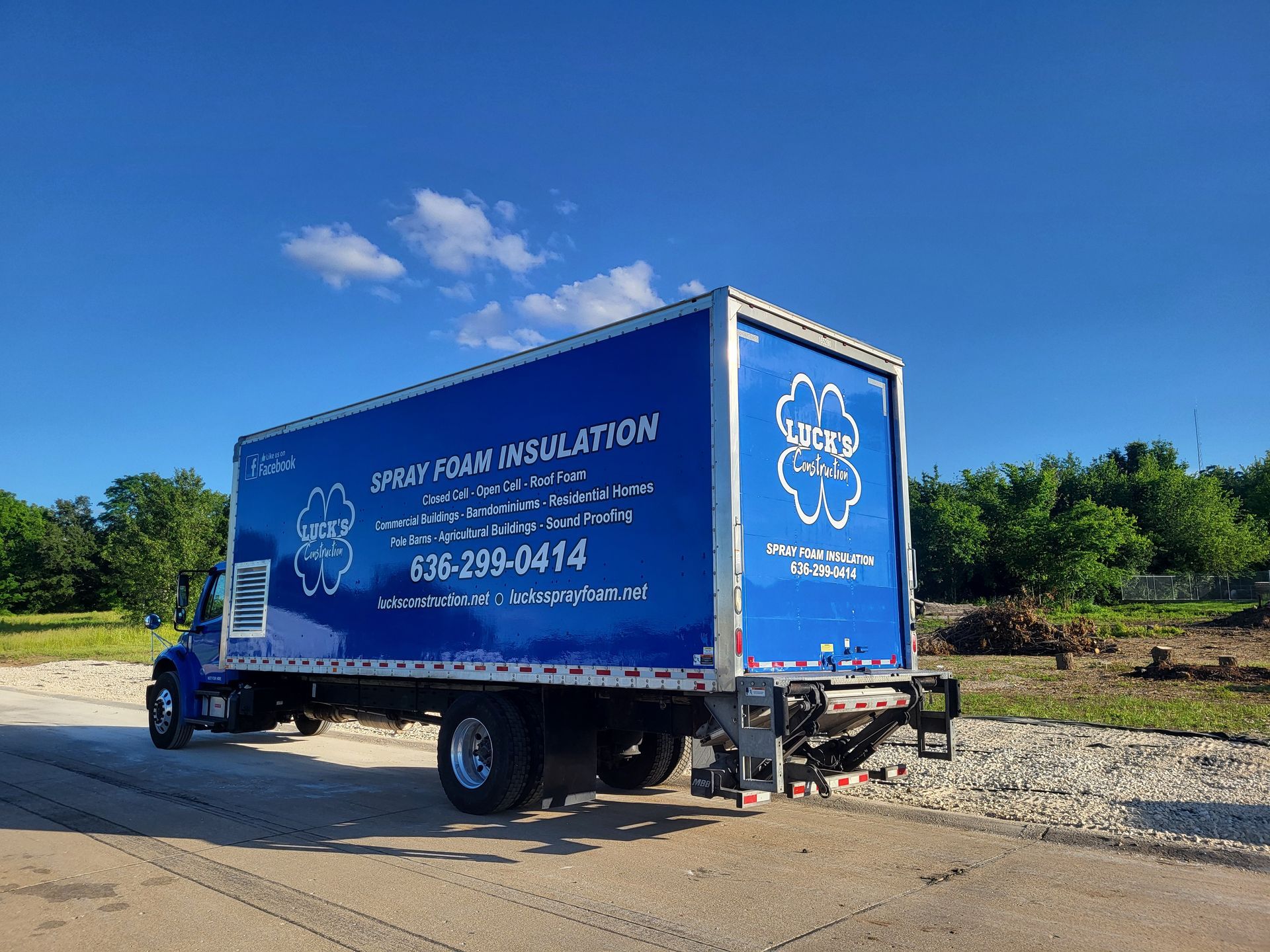 A blue foam insulation truck is parked on the side of the road.