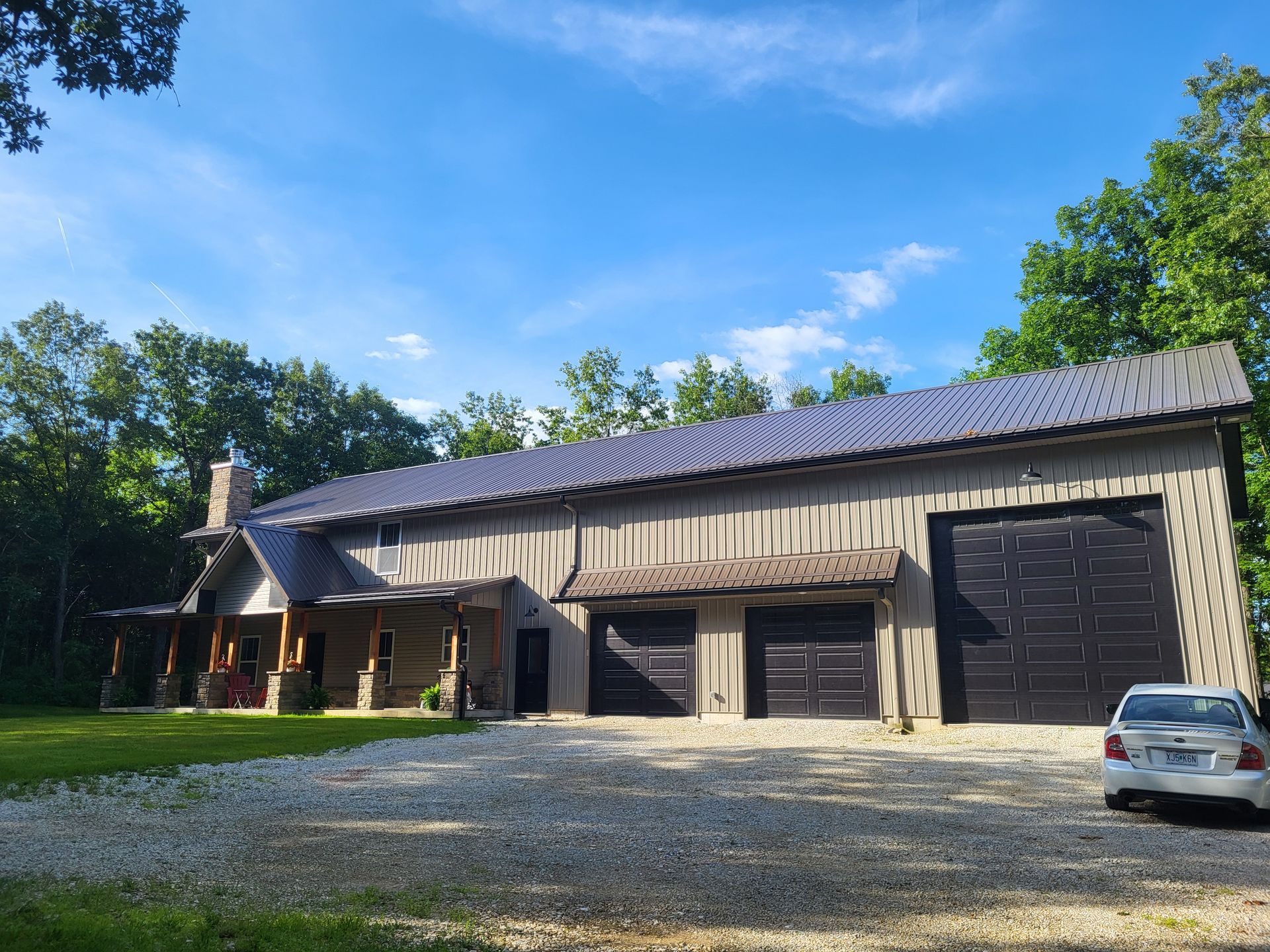 A large house with a car parked in front of it.