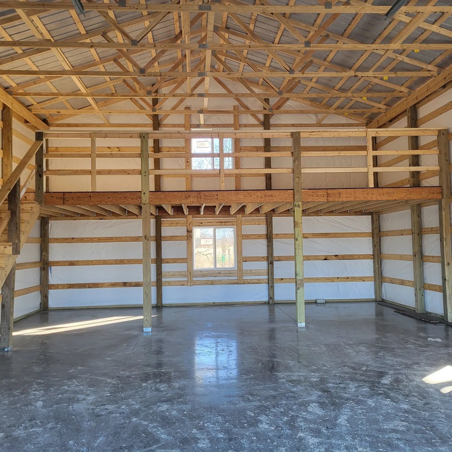 An empty room with a wooden ceiling and a balcony