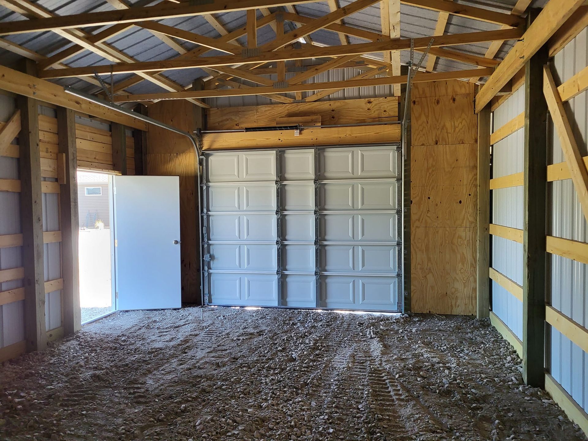 A garage with a white garage door and a white door.