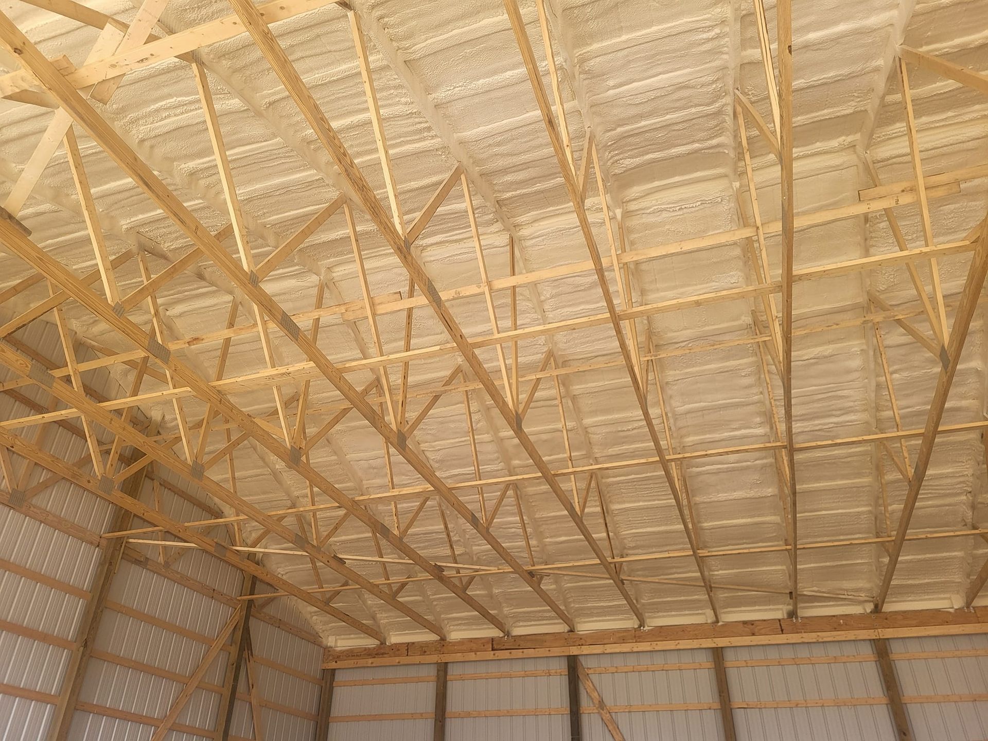 The ceiling of a building under construction with wooden beams.
