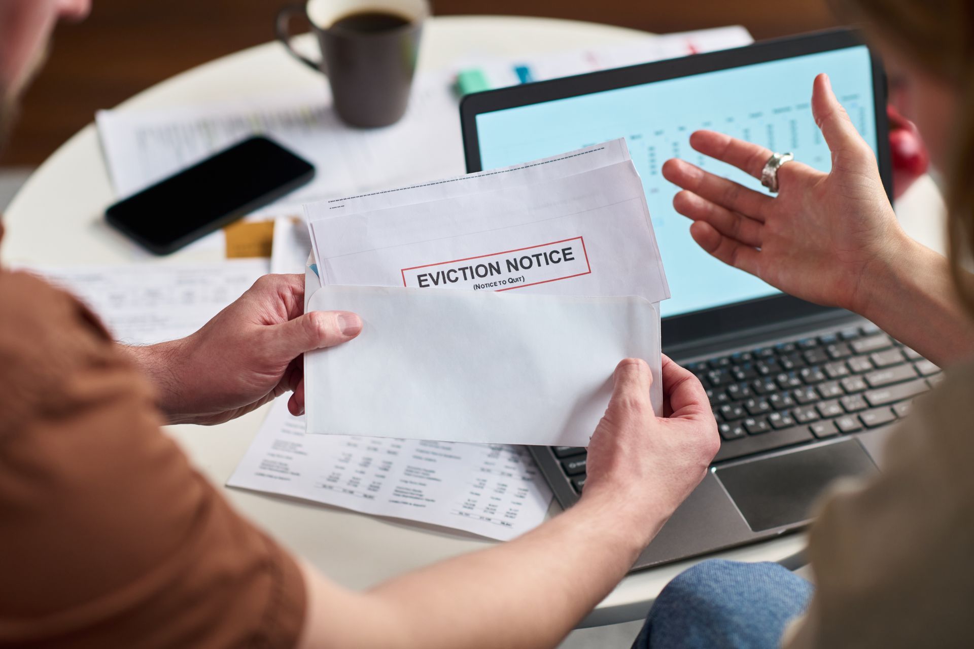Man holding an envelope that reads “eviction notice