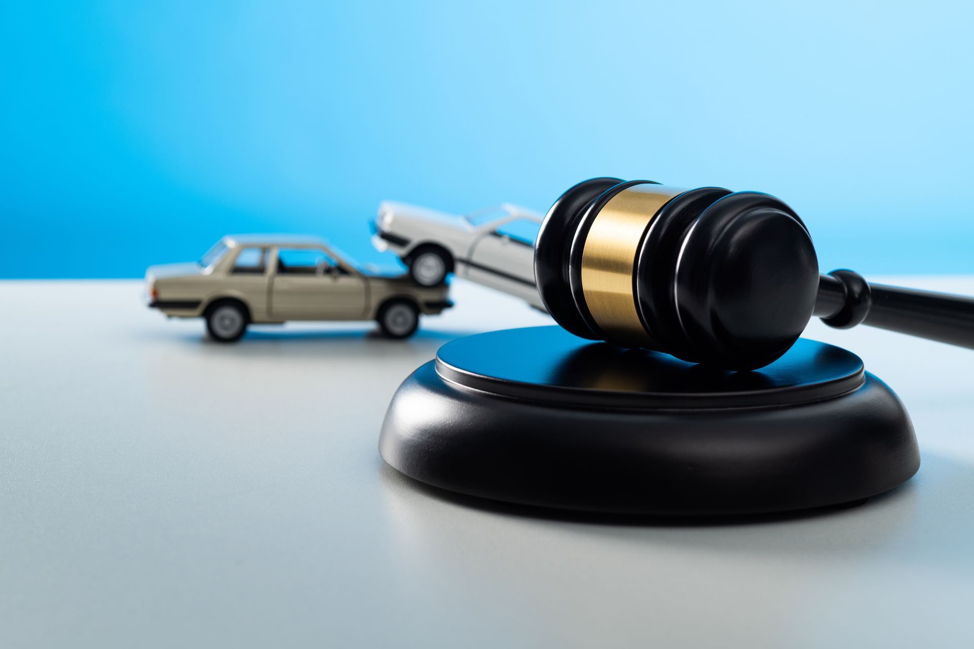 Gavel and model cars on the table.