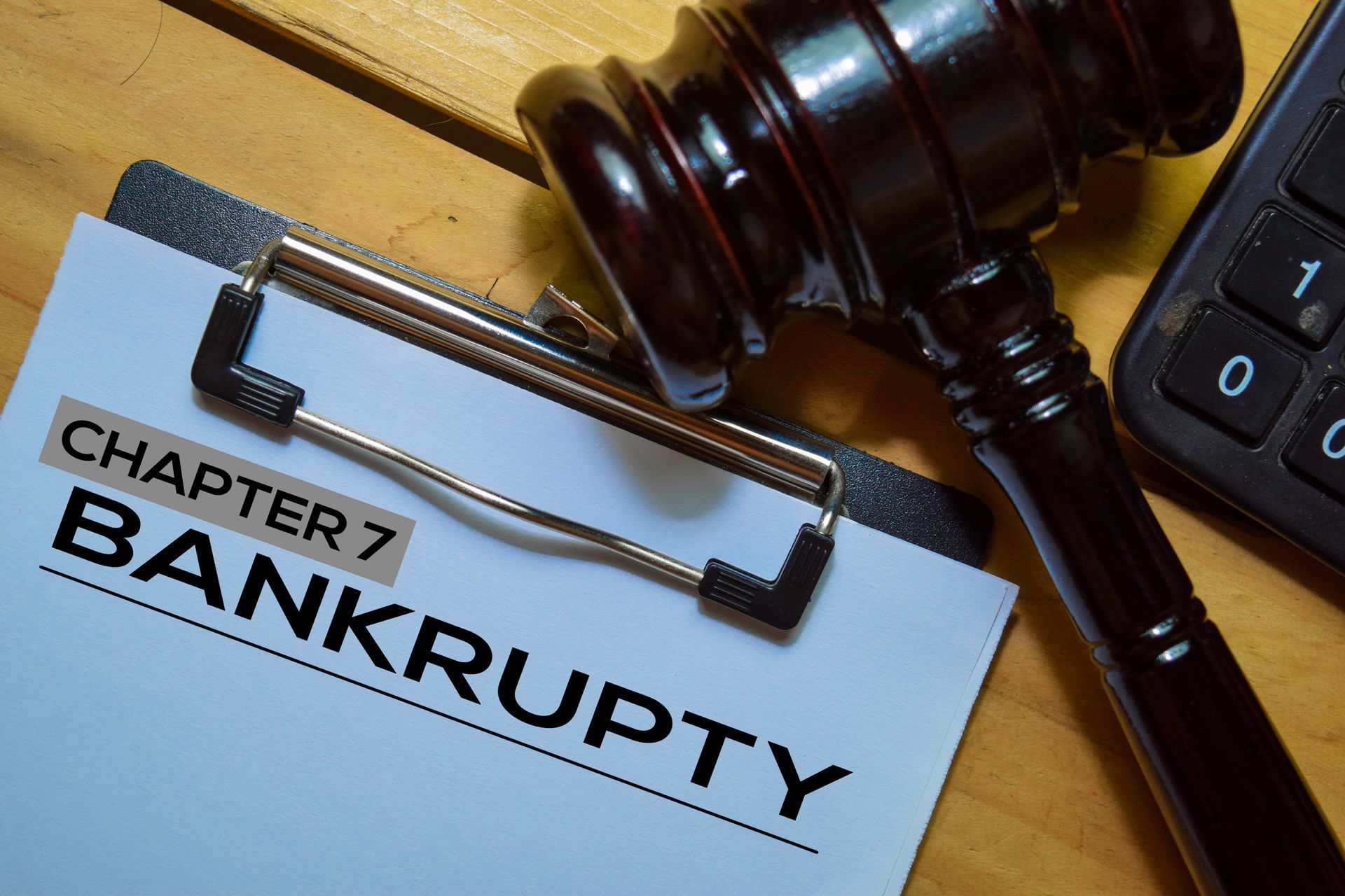 Chapter 7 bankruptcy text in a document and a gavel isolated on an office desk.