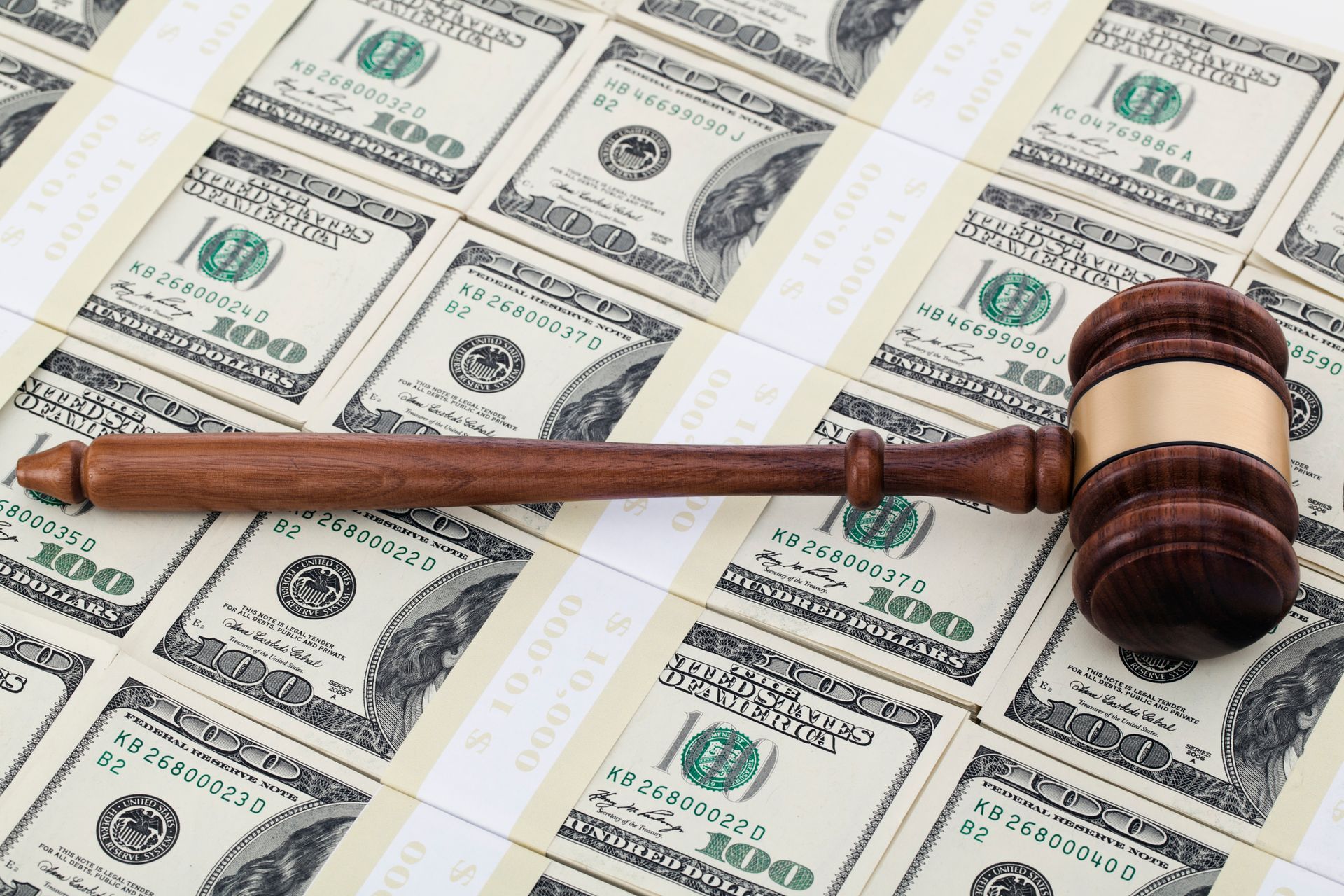 Wooden gavel on one hundred dollar bills. Wooden gavel on one hundred dollar bills.
