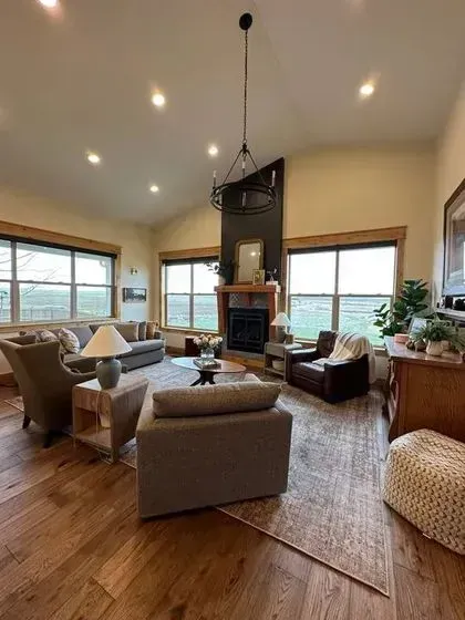 Spacious, warmly lit living room with large windows