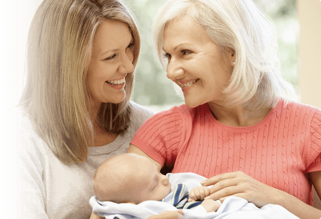 Happy Women Holding a Baby — Tucson, AZ — Associated Dermatologist