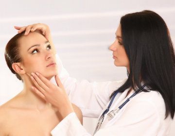Doctor Examining the Face of Patient — Tucson, AZ — Associated Dermatologist