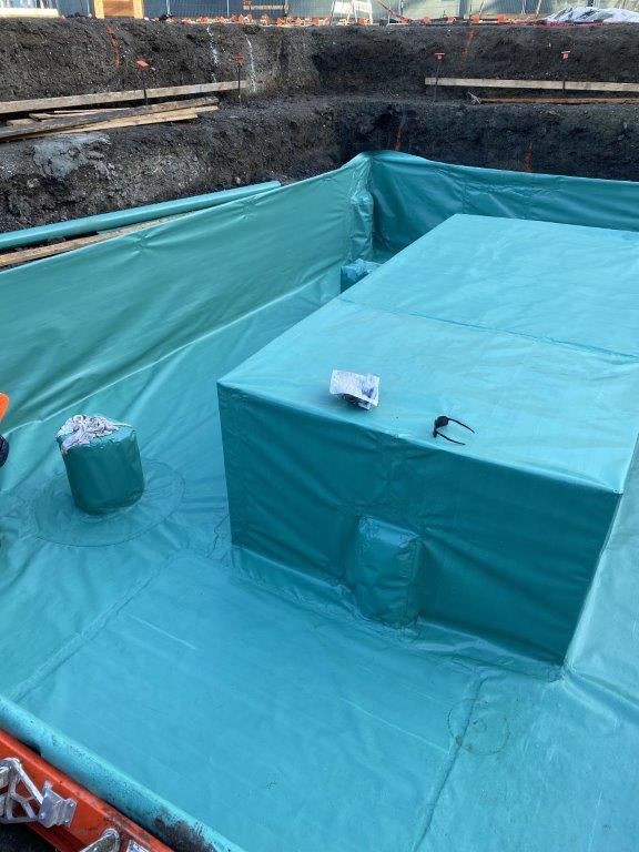 A large green tarp is covering a large hole in the ground.  | Oakland, CA  | Diablo Roofing