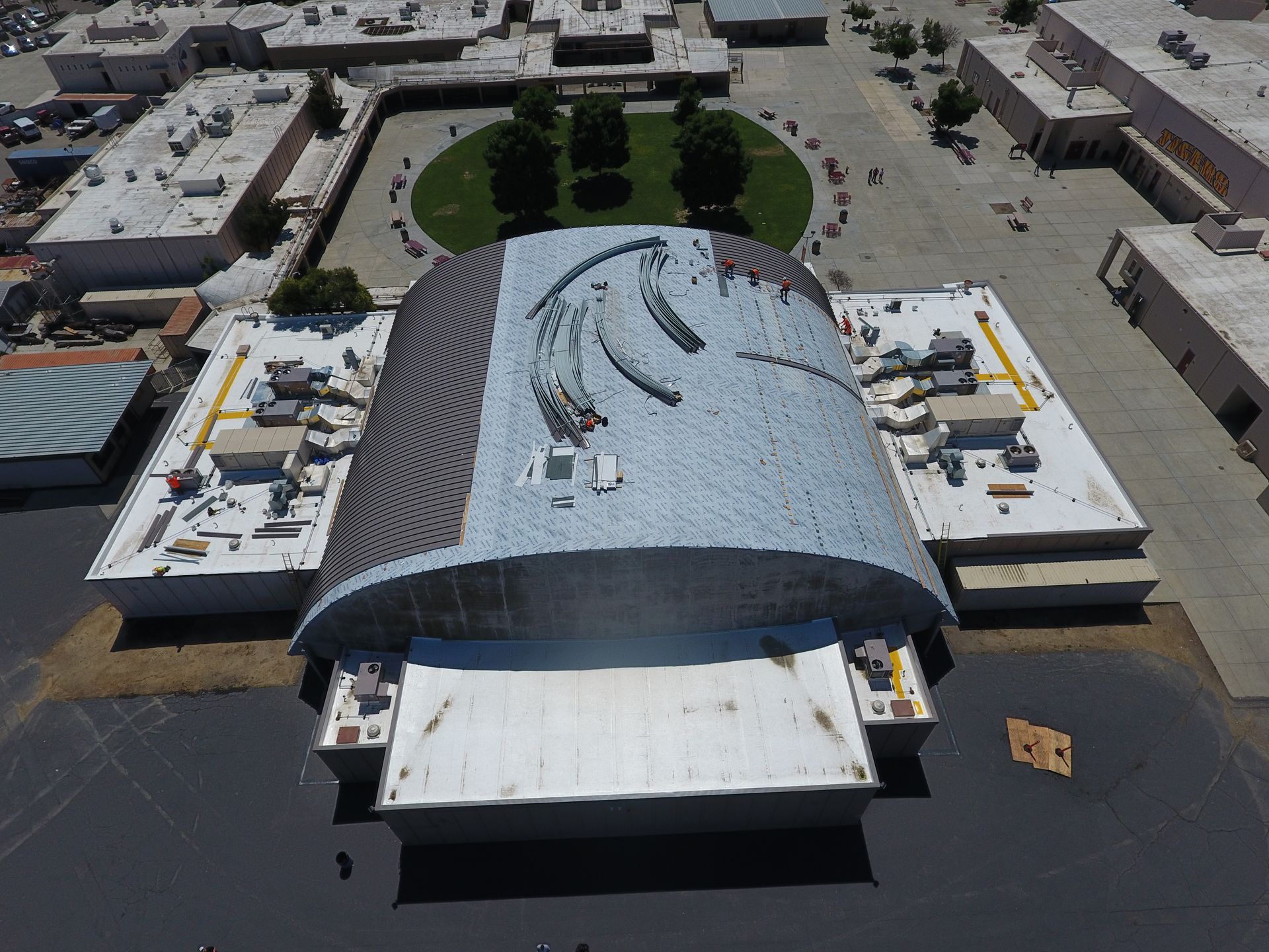 An aerial view of a large building with a curved roof  | Oakland, CA  | Diablo Roofing