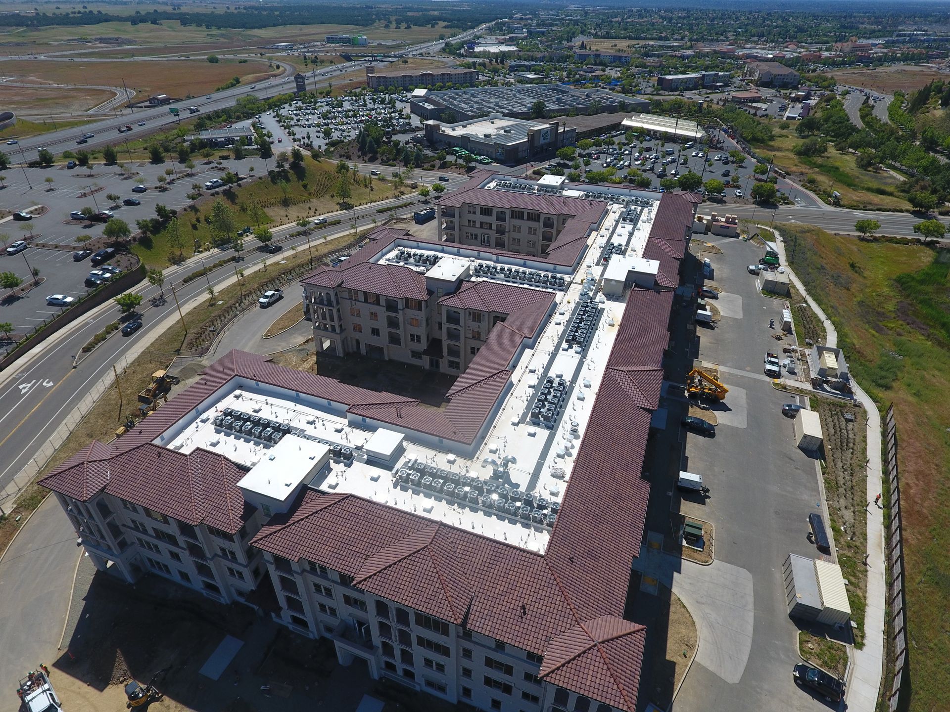 An aerial view of a large building with a lot of cars parked in front of it.  | Oakland, CA  | Diablo Roofing