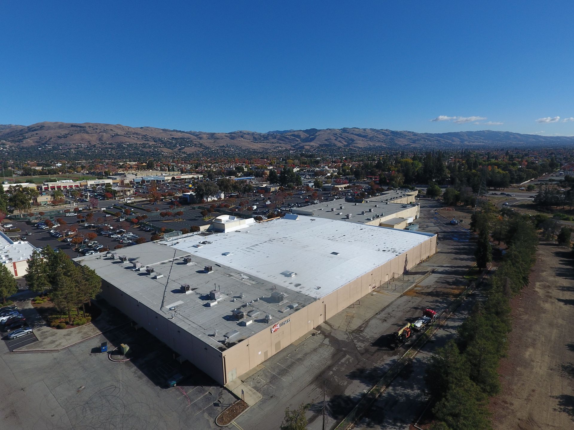 An aerial view of a large building with a white roof.  | Oakland, CA  | Diablo Roofing