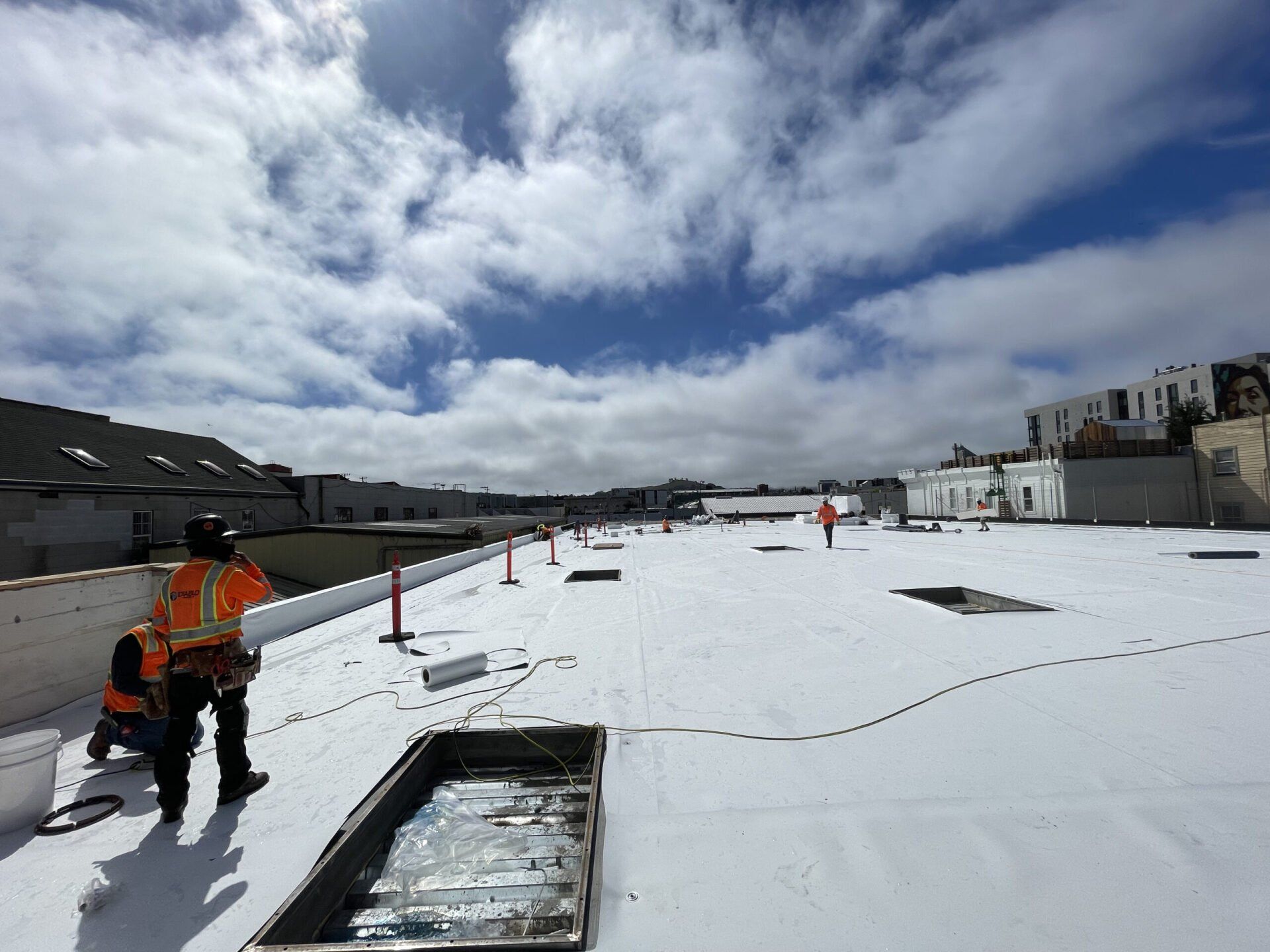 Two men are working on a snow covered roof.  | Oakland, CA  | Diablo Roofing