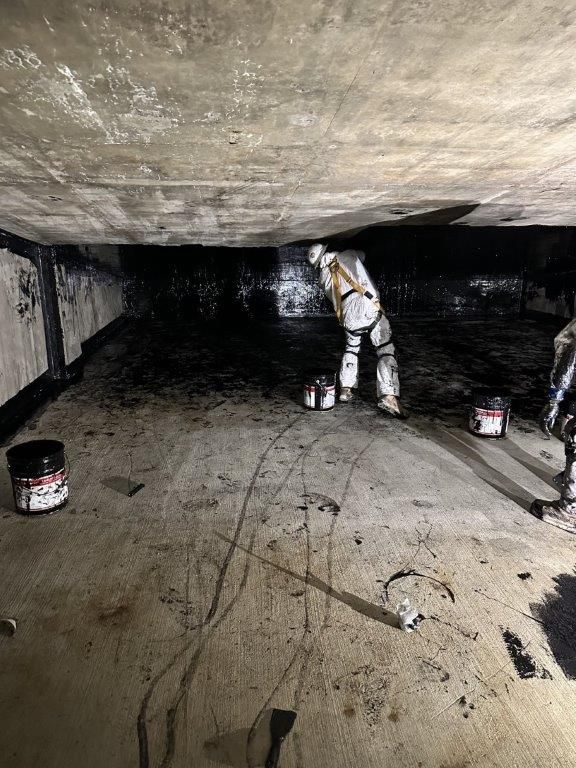 A man is standing in a dark room with a vacuum cleaner.  | Oakland, CA  | Diablo Roofing