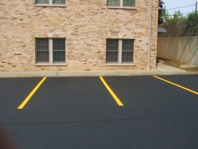 A brick building with a parking lot in front of it