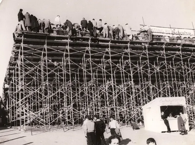 A black and white photo of a building under construction