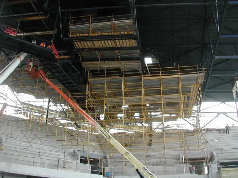 A large building under construction with scaffolding and a crane.