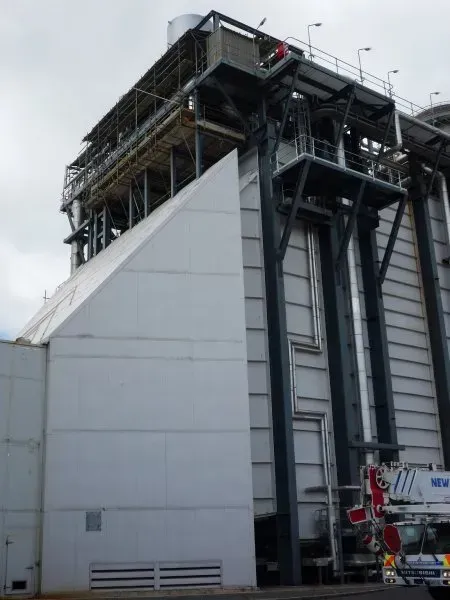 A large white building with a staircase on top of it