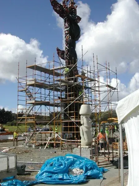 A large statue is being built with scaffolding around it