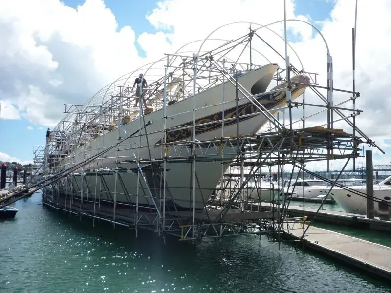 A boat is sitting on a dock with scaffolding around it