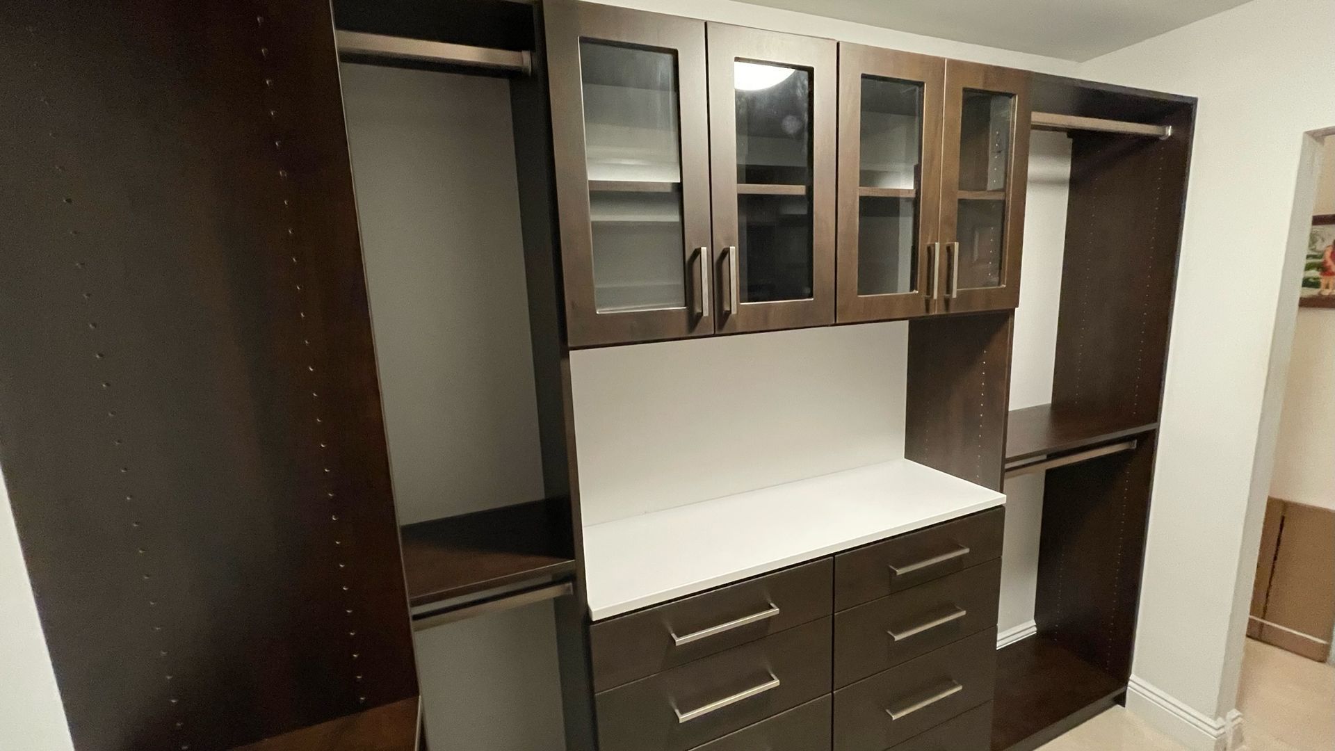 A large closet with lots of drawers and cabinets