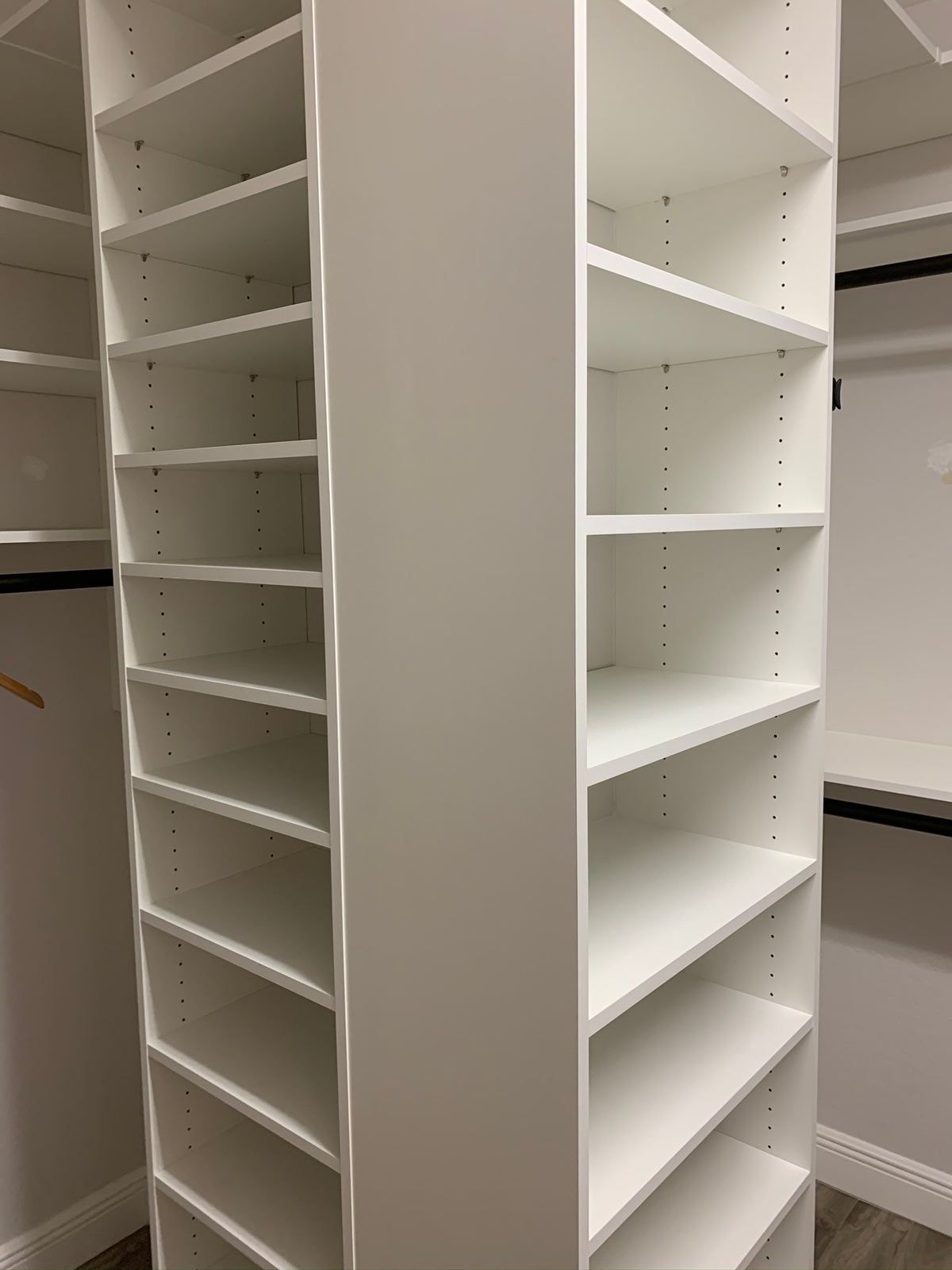 A closet with lots of shelves and a hanger.