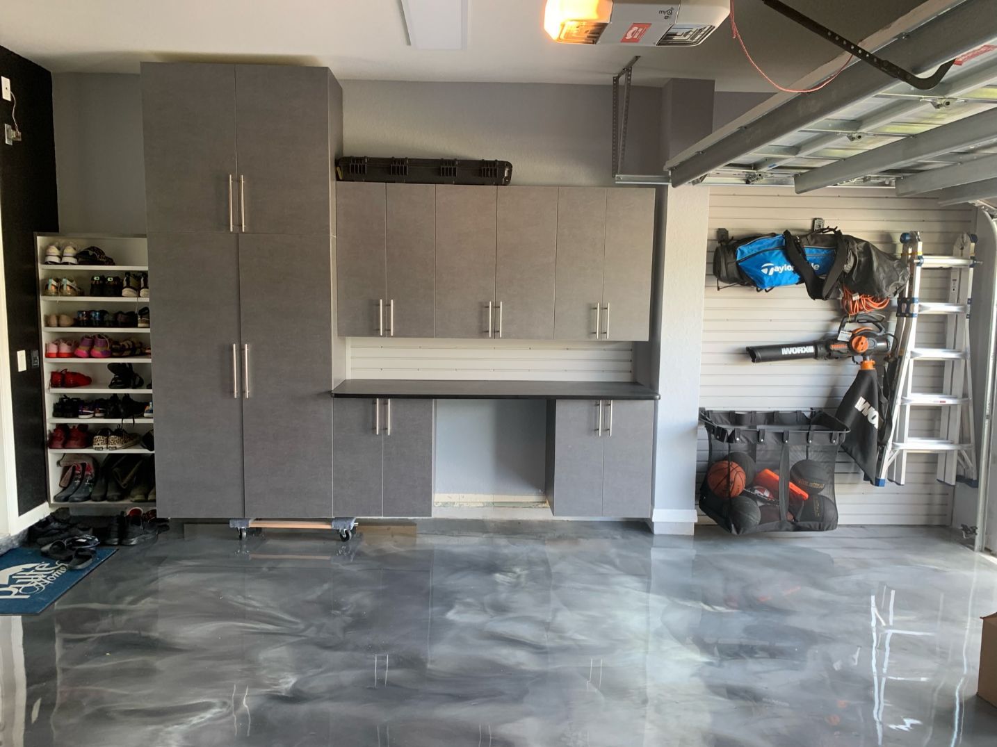 Pewter Garage Cabinets With Slatwall Organizer System and Epoxy Flooring
