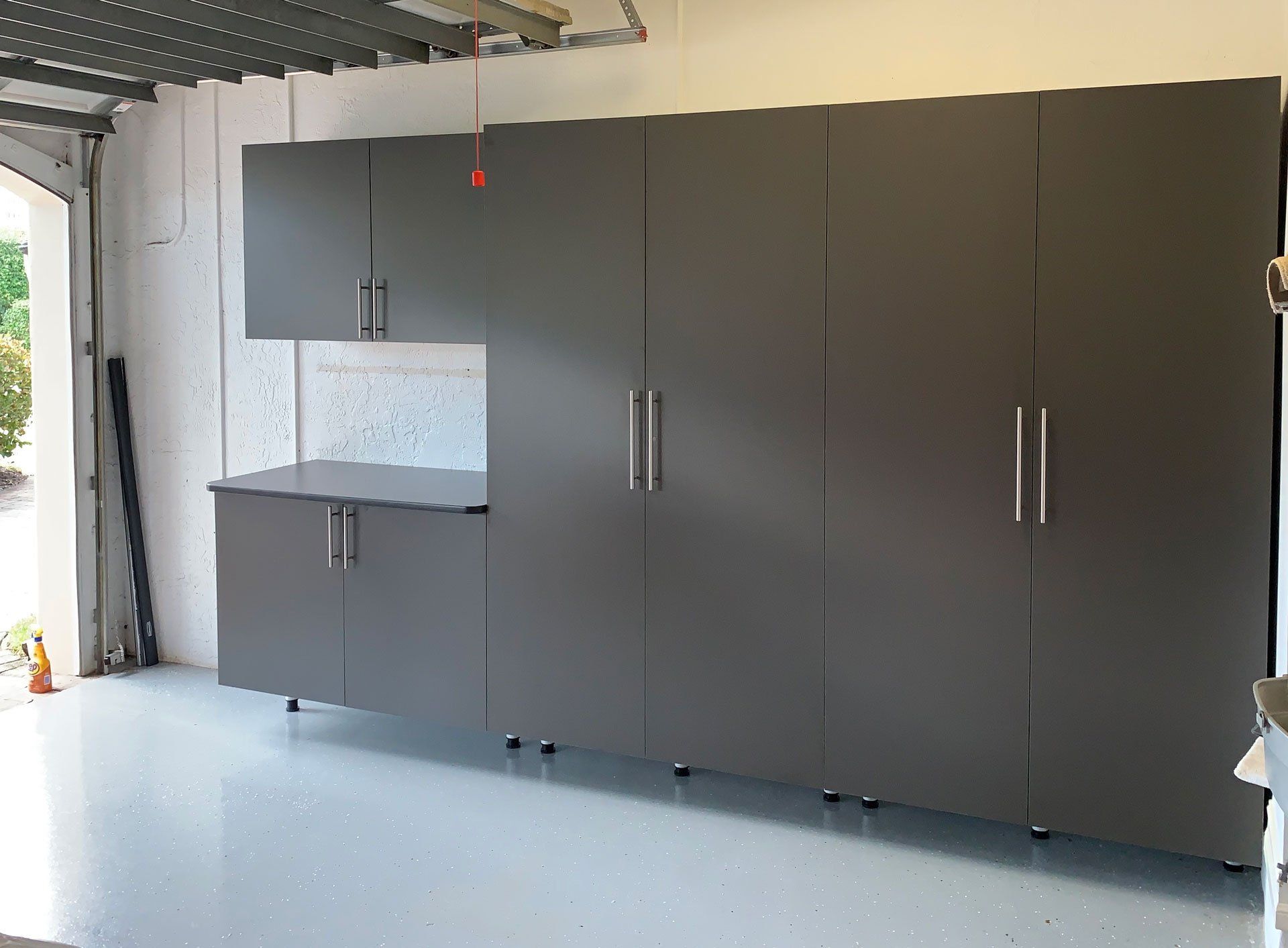 A garage with a lot of cabinets and a counter top.