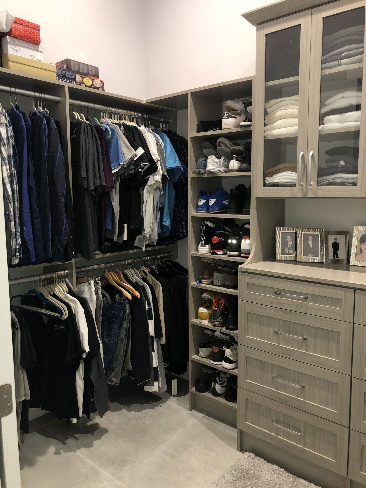 A walk in closet filled with lots of clothes and shoes.