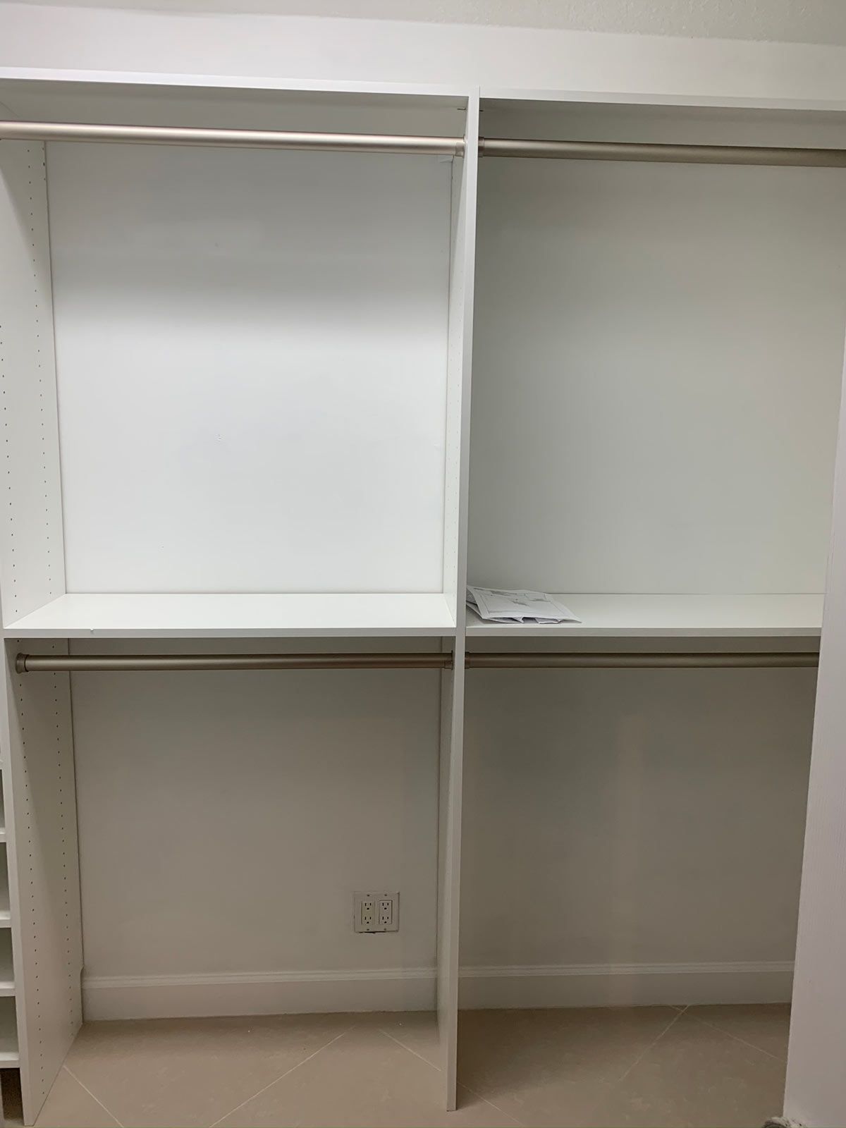 A closet with a lot of shelves and clothes racks.