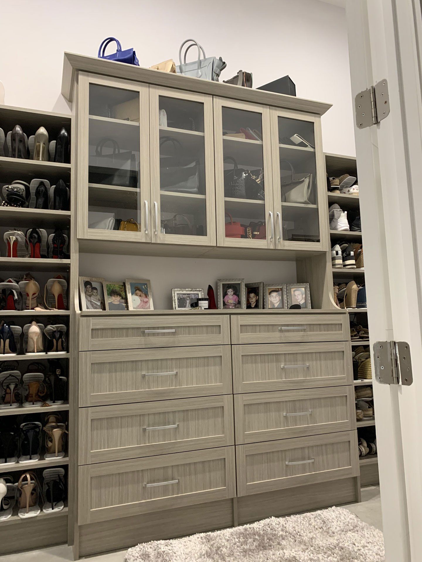 A closet filled with lots of shoes and handbags