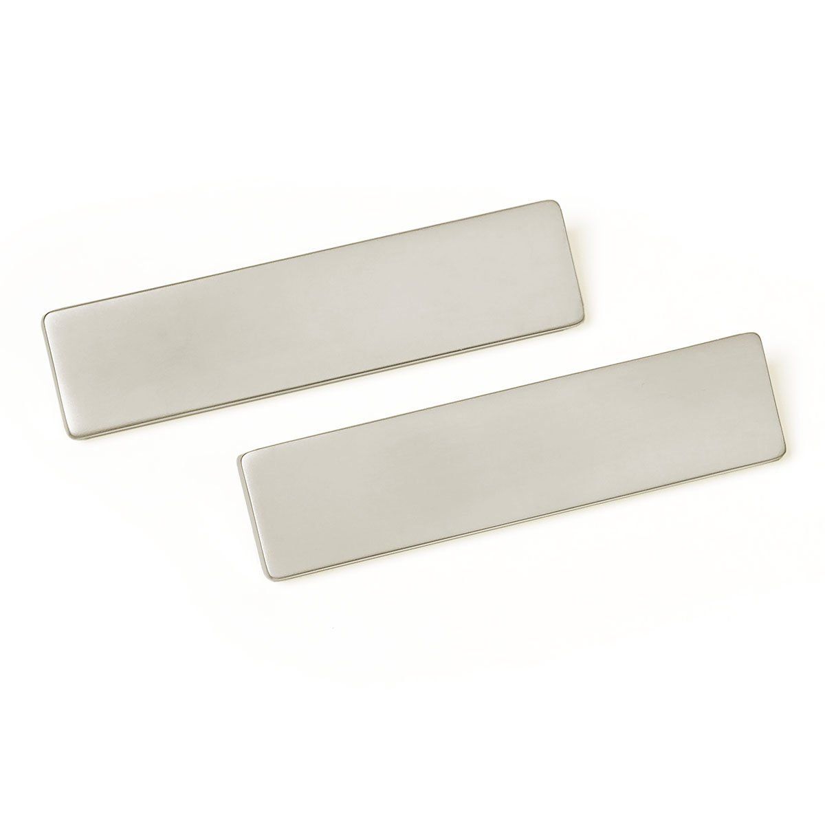 A pair of stainless steel hair clips on a white background.