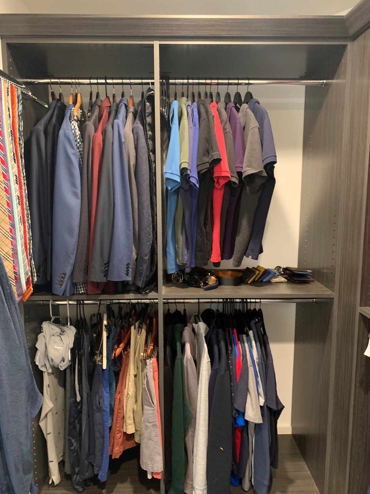 A closet filled with lots of clothes and ties.