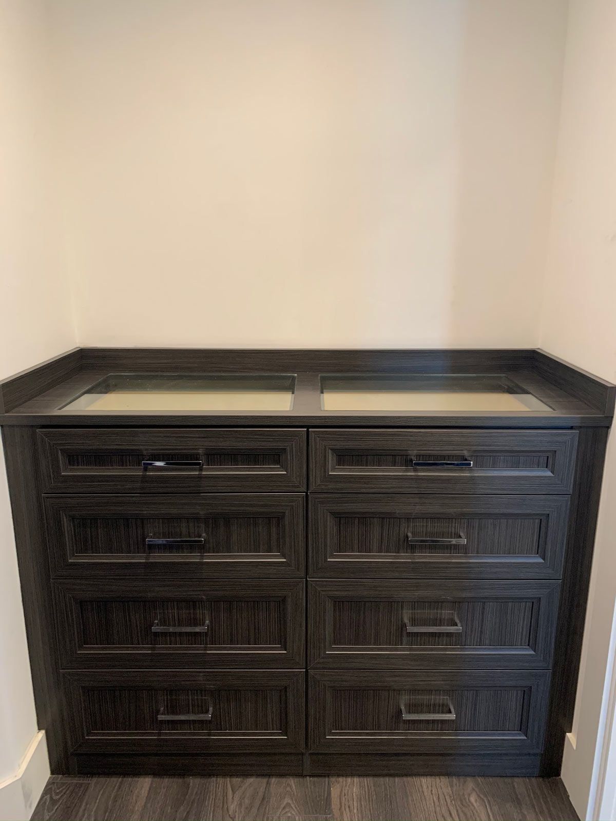 A dresser with two drawers and a sink in a room.