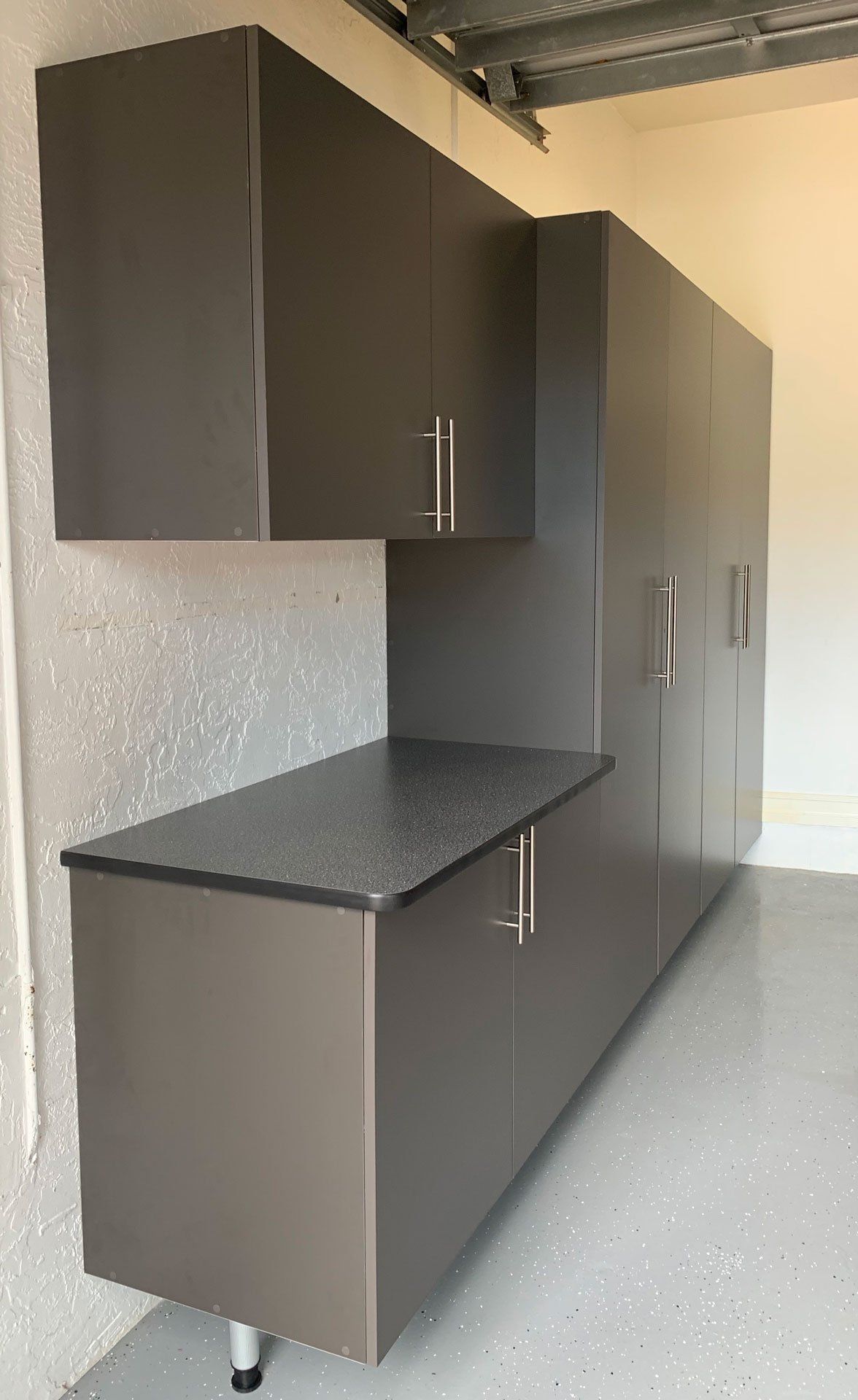 A garage with a lot of cabinets and a counter top.