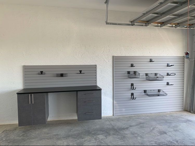 Small Garage - Base Cabinets With Workbench. Slatwall Above and Section of Slatwall Adjacent to Workbench