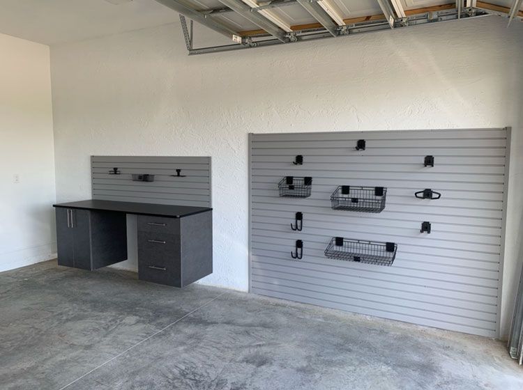 Small Garage - Base Cabinets With Workbench. Slatwall Above and Section of Slatwall Adjacent to Workbench