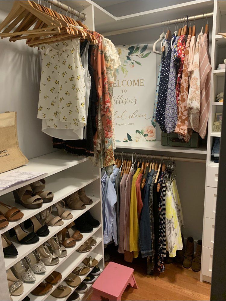 A closet filled with clothes and shoes and a sign that says welcome