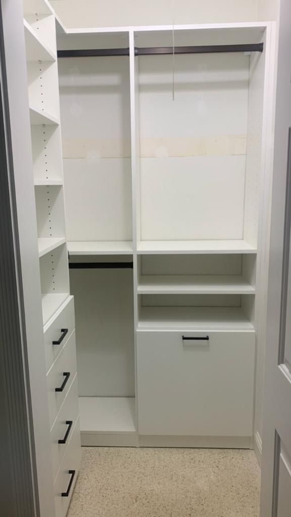 A small closet with lots of shelves and drawers.