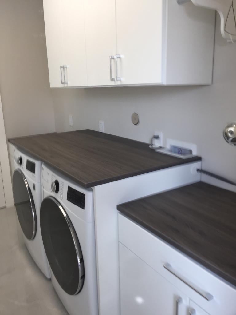White Laundry System With Ash Countertops