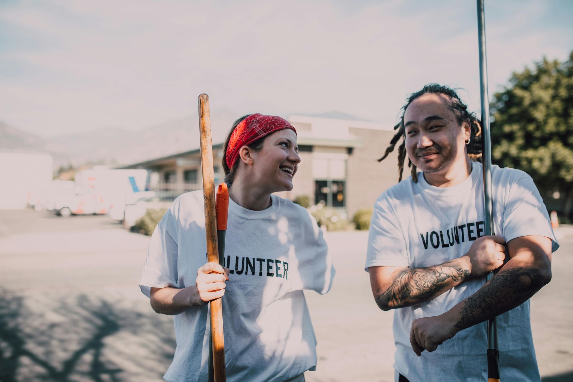 Two smiling volunteers in white shirts with 