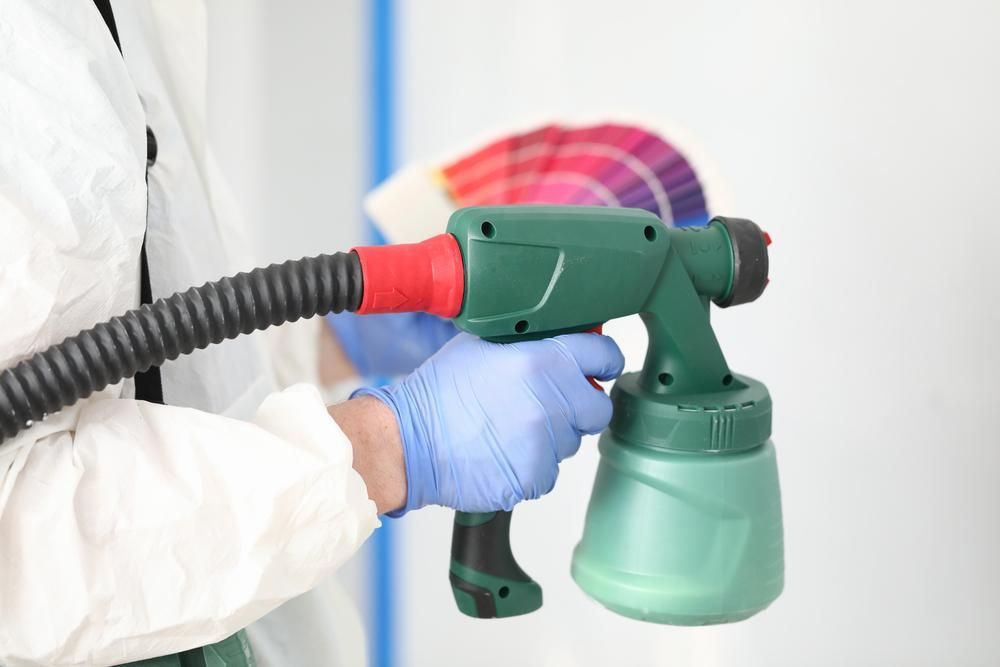 The Man is Carrying a Spray Paint Equipment and a Color Palette — Alamo Powder Coaters in Mittagong, NSW