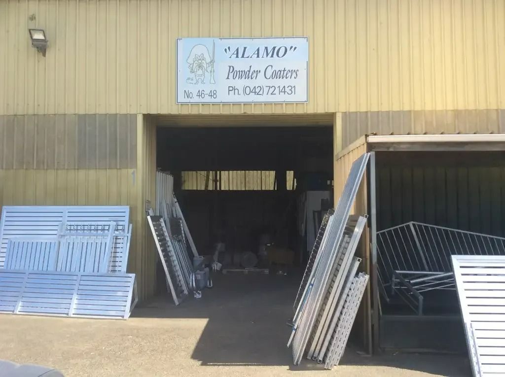 A Building With Metal And Aluminium Slat Screens — Alamo Powder Coaters in Unanderra, NSW