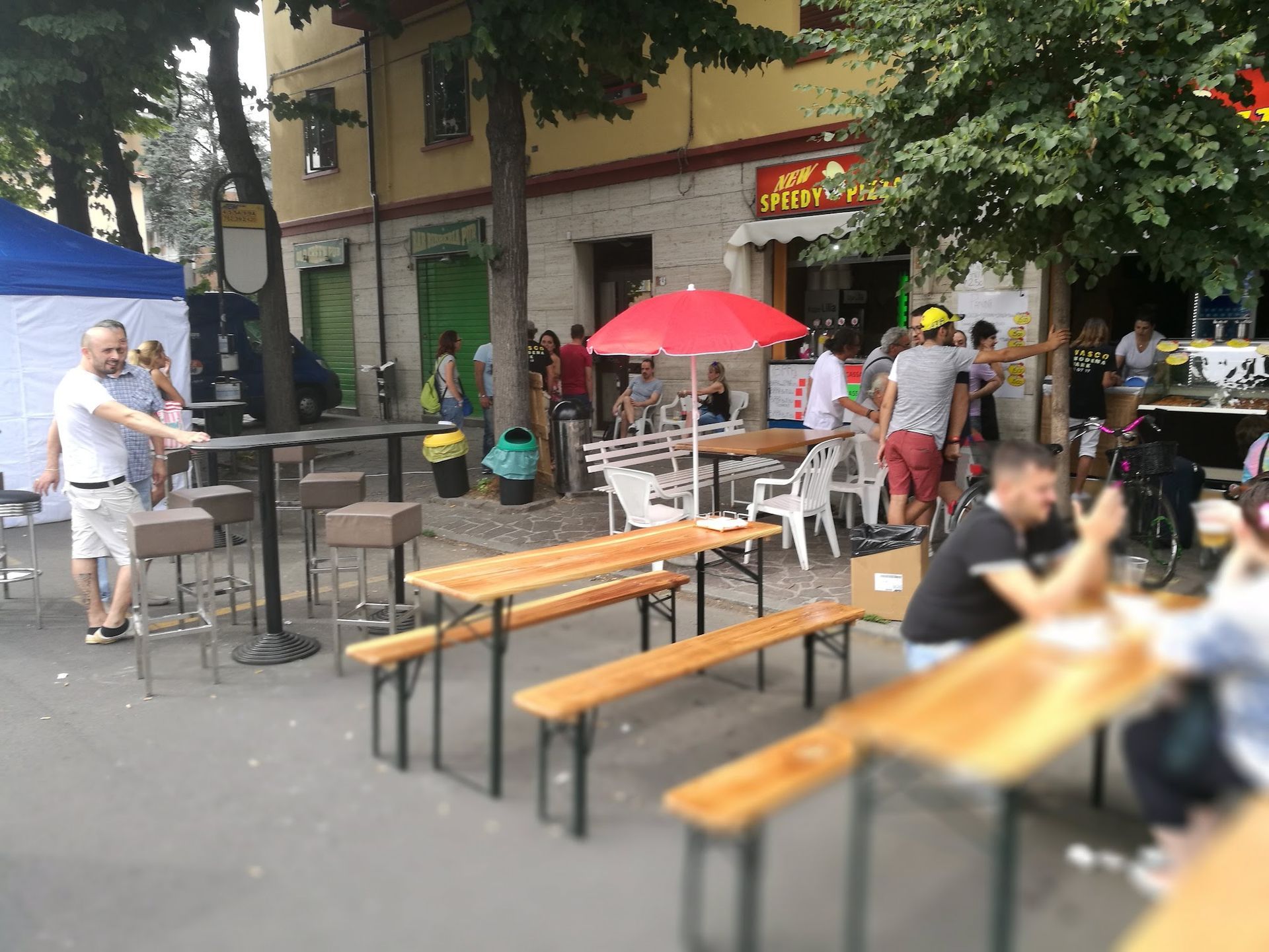 Un gruppo di persone è seduto ai tavoli fuori di un ristorante